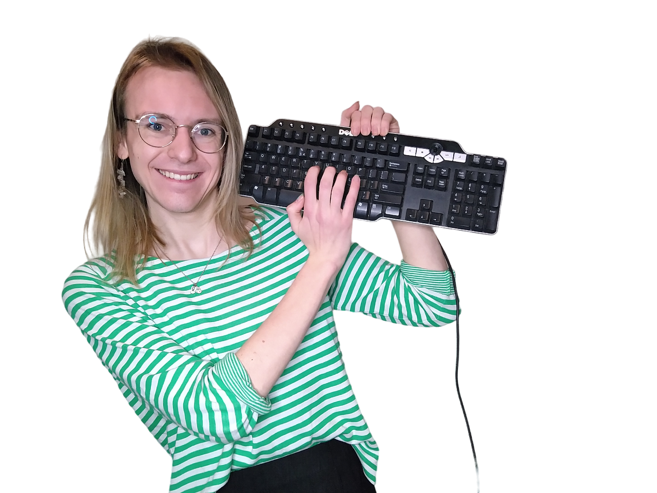 Jenny is holding a computer keyboard next to her head. Her other hand is on the keys. She's looking into the camera and smiling.