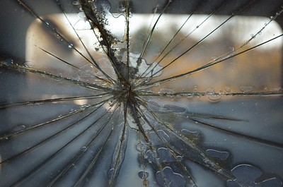A close-up photo of a cracked windshield.