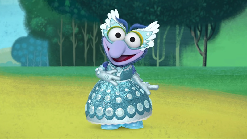 Screenshot van Muppet Babies met Gonzo in een glinsterende blauwe baljurk met oogmasker.