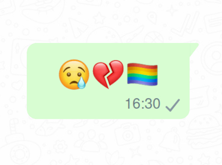 Een screenshot van een verstuurd WhatsApp bericht met drie emojis: een droevige emoji met een traan, een gebroken hart en een regenboogvlag.