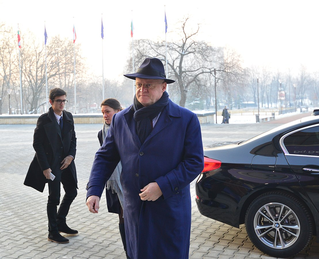 Caretaking minister of Justice en Security Ferdinand Grapperhaus, wearing a long blue trenchcoat and a spy-style hat.